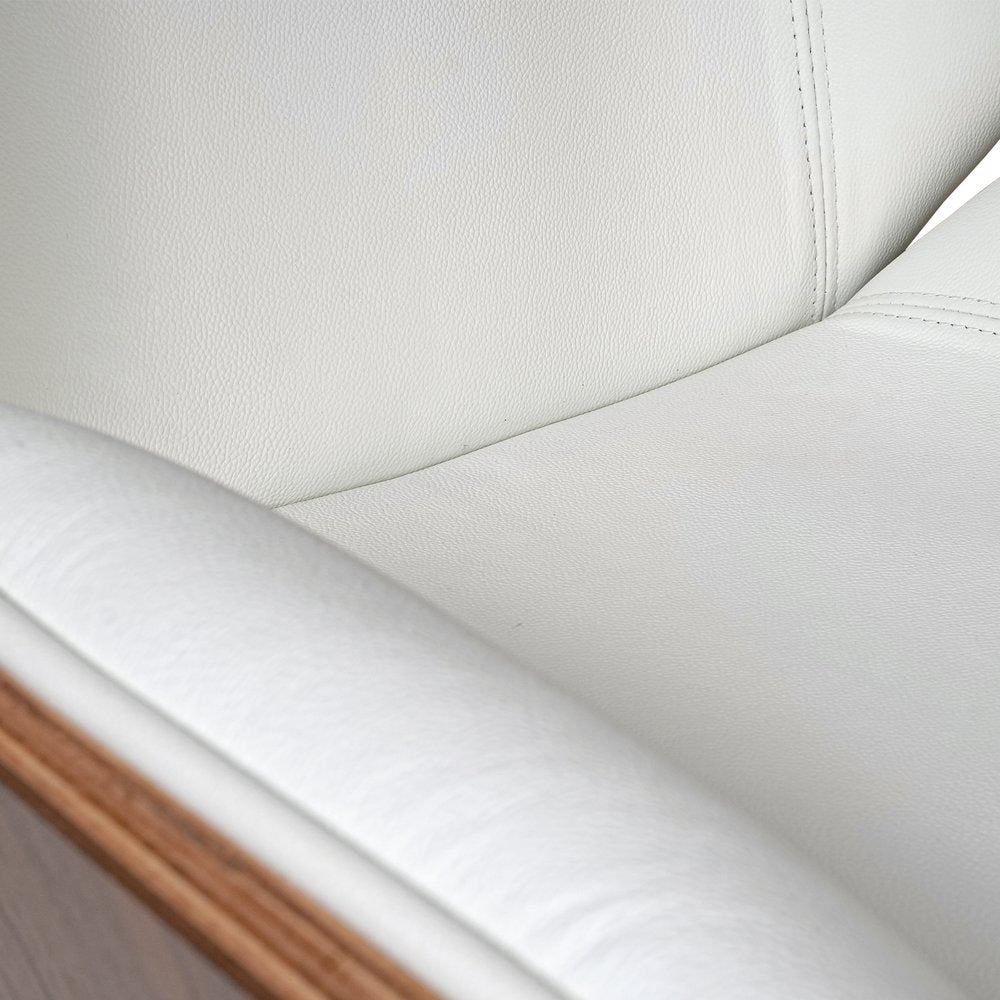 Close-up of a white leather car seat with stitching details
